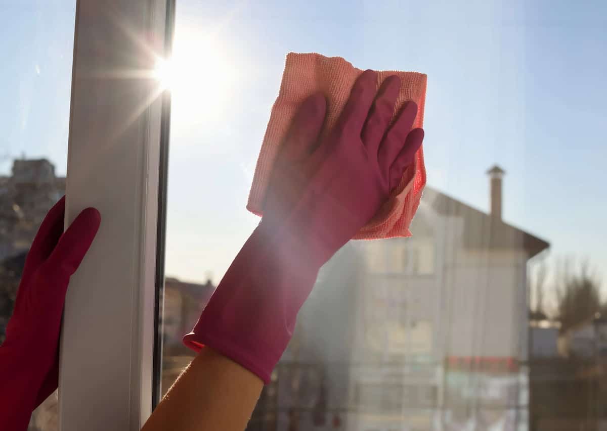 Cleaning window with cloth and gloves