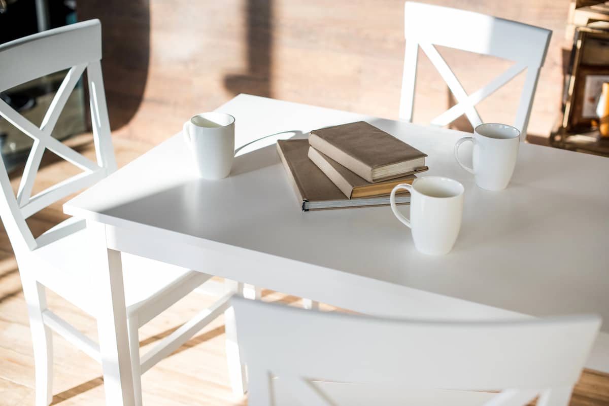 The Many Benefits of Natural Light in the Home White table with books and coffee mugs